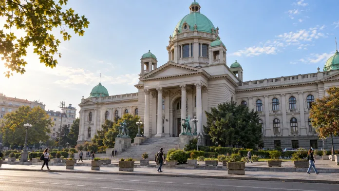 Ilustracija jutarnjeg gradskog prizora ispred Narodne skupštine u Beogradu.